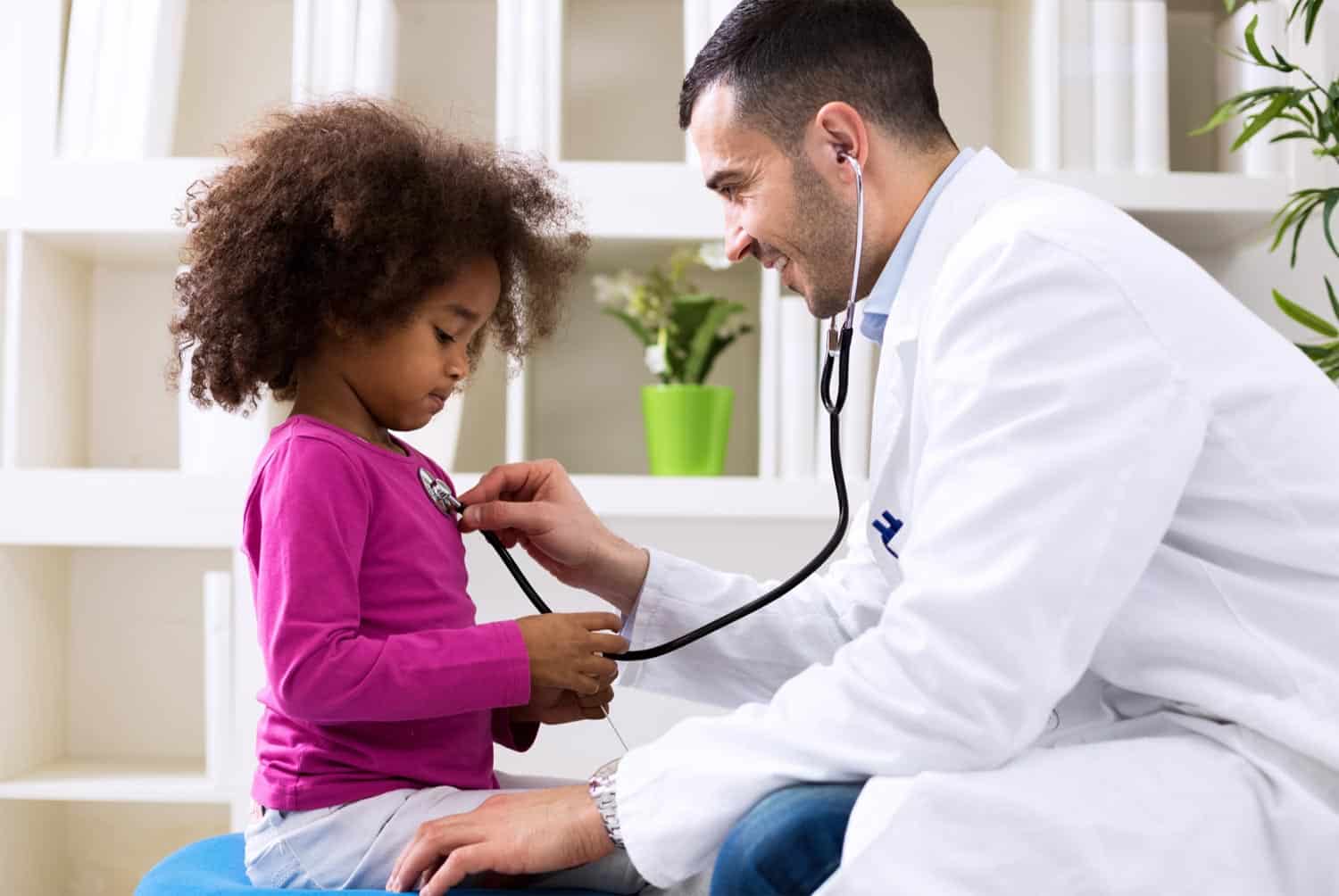 Doctor listening to a child's heart beat with a stethoscope