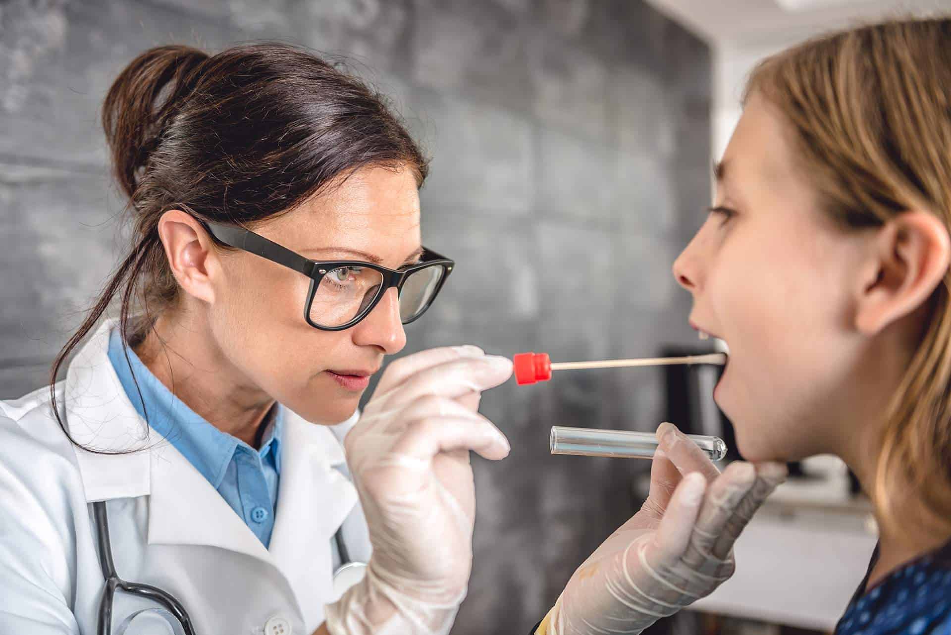 Doctor performing strep test.